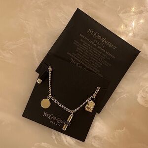 Yves Saint Laurent Silver Charm Bracelet with Gold Accents